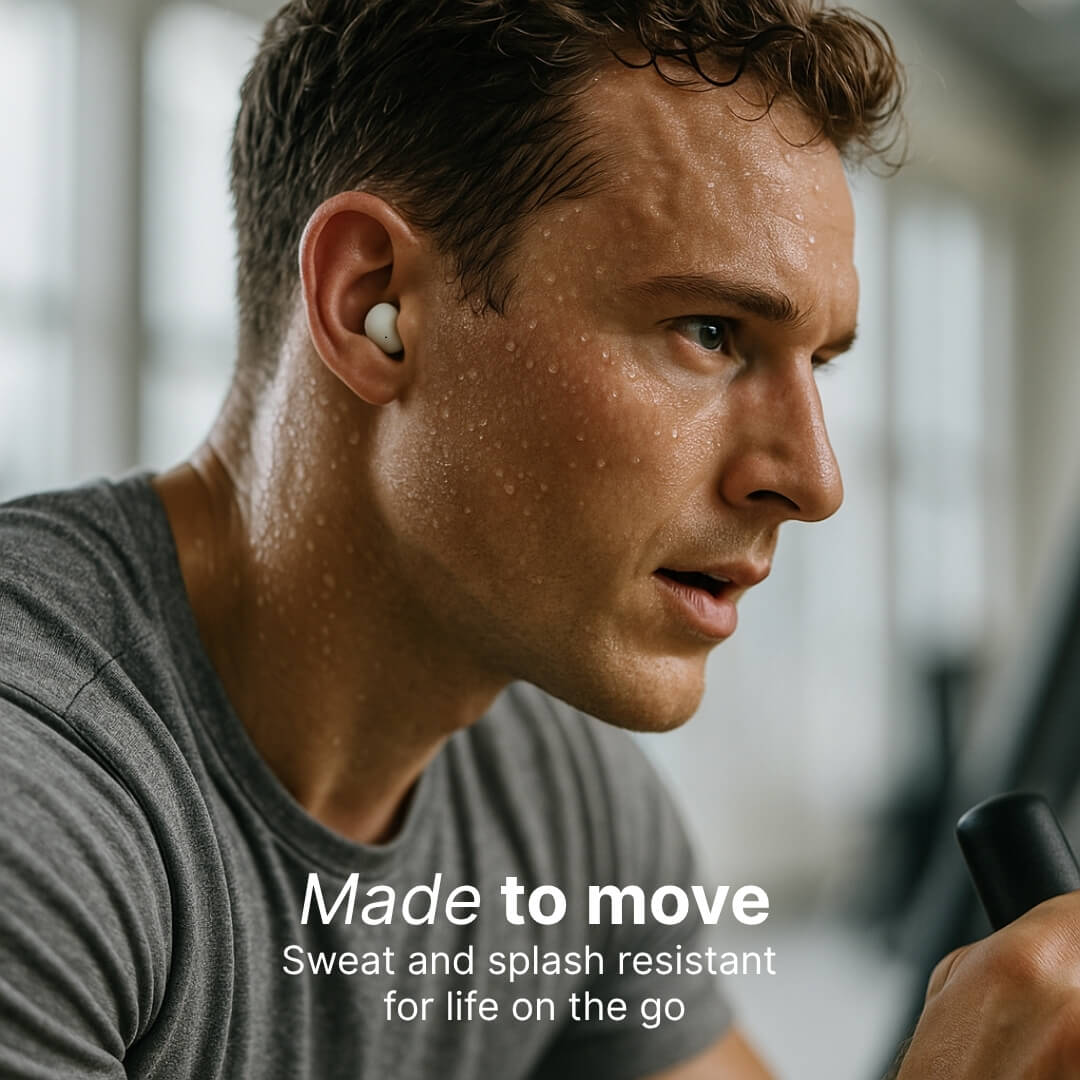 Photograph of an intense, sweating man wearing a white wireless earbud and a grey t-shirt exercising in a gym, with the overlay text Made to move Sweat and splash resistant for life on the go