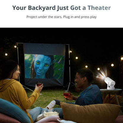 Two people enjoying an outdoor backyard movie night, watching the blue-skinned Neytiri from Avatar projected on a screen, featuring a white portable projector, and illuminated by string lights