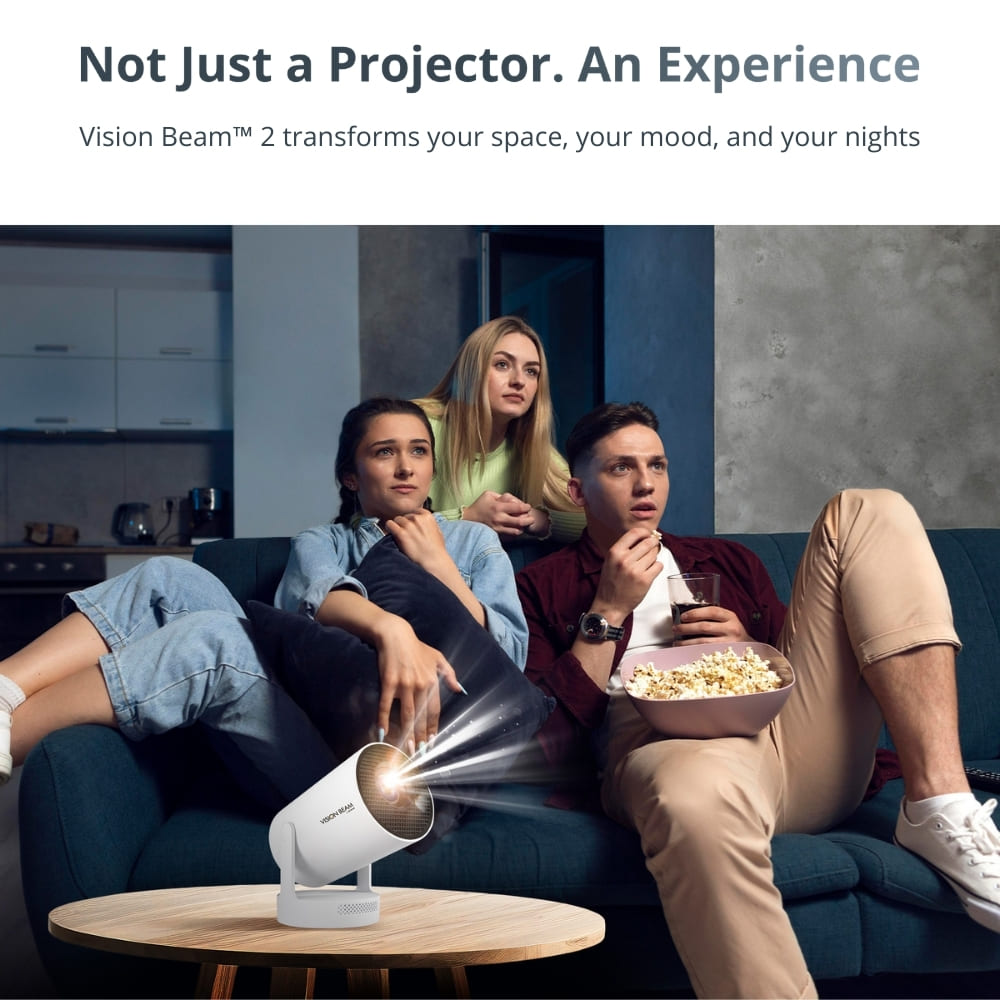 Three young adults on a teal couch enjoying a movie projected by a white Vision Beam™ 2, with one man holding a pink bowl of popcorn and a drink