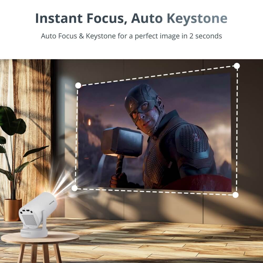 Promotional graphic showing a white smart projector on a round wooden table projecting a vivid battle scene of Captain America holding Thor's hammer Mjolnir onto a wall in a stylish room with a green plant and wooden floor