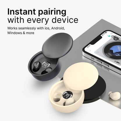 Product photograph of two open wireless earbud charging cases, one black showing 100% charge and one beige showing 99%, displayed alongside a smartphone with a record player music app and prominent text "Instant pairing with every device"