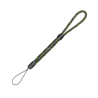 A braided paracord wrist strap in a green yellow black camouflage pattern featuring two black plastic adjusters and a thin attachment loop