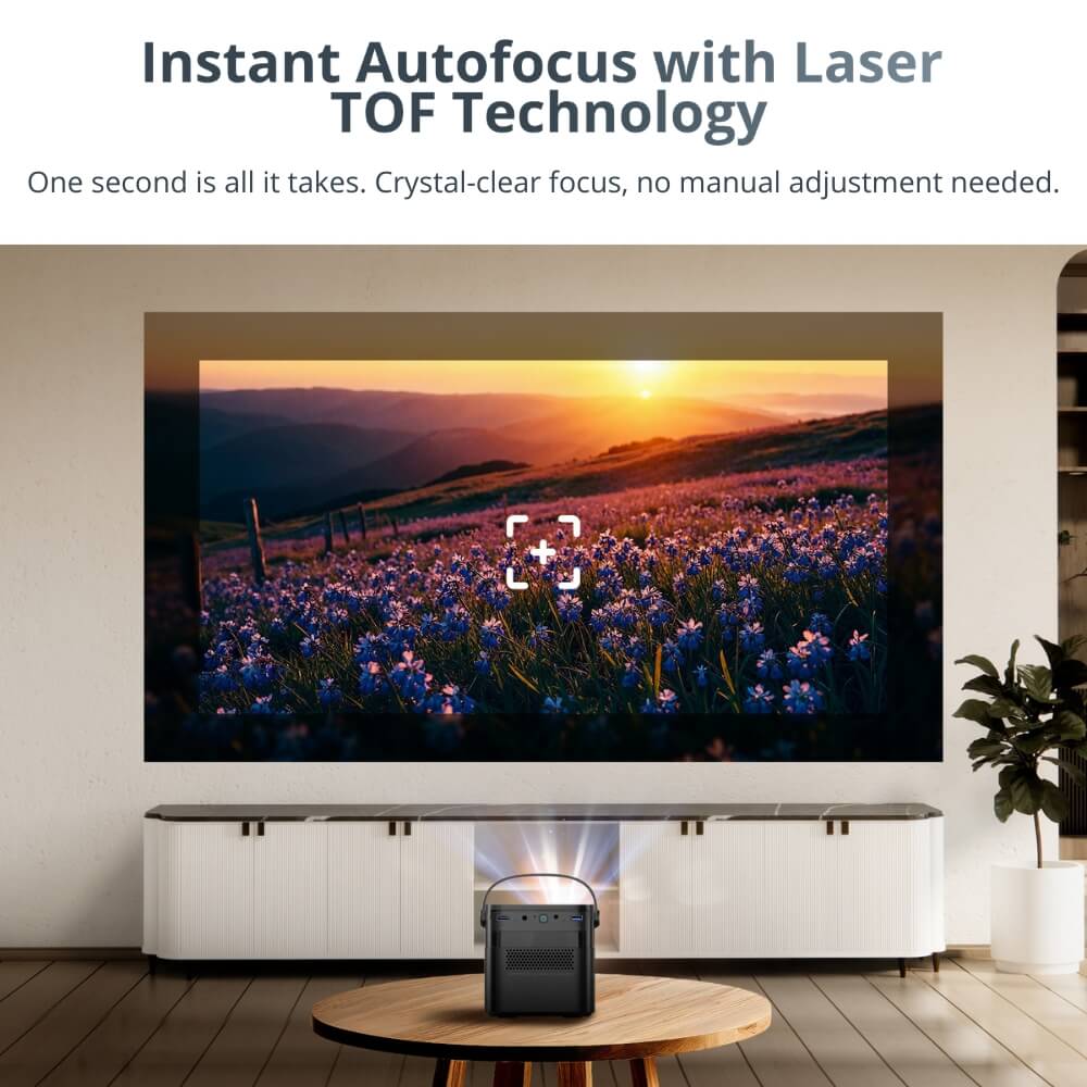 Digital advertisement of a black portable projector on a round wooden coffee table in a modern living room projecting a vibrant sunset over a field of purple flowers and rolling hills onto a wall, featuring a white autofocus target icon demonstrating laser TOF technology