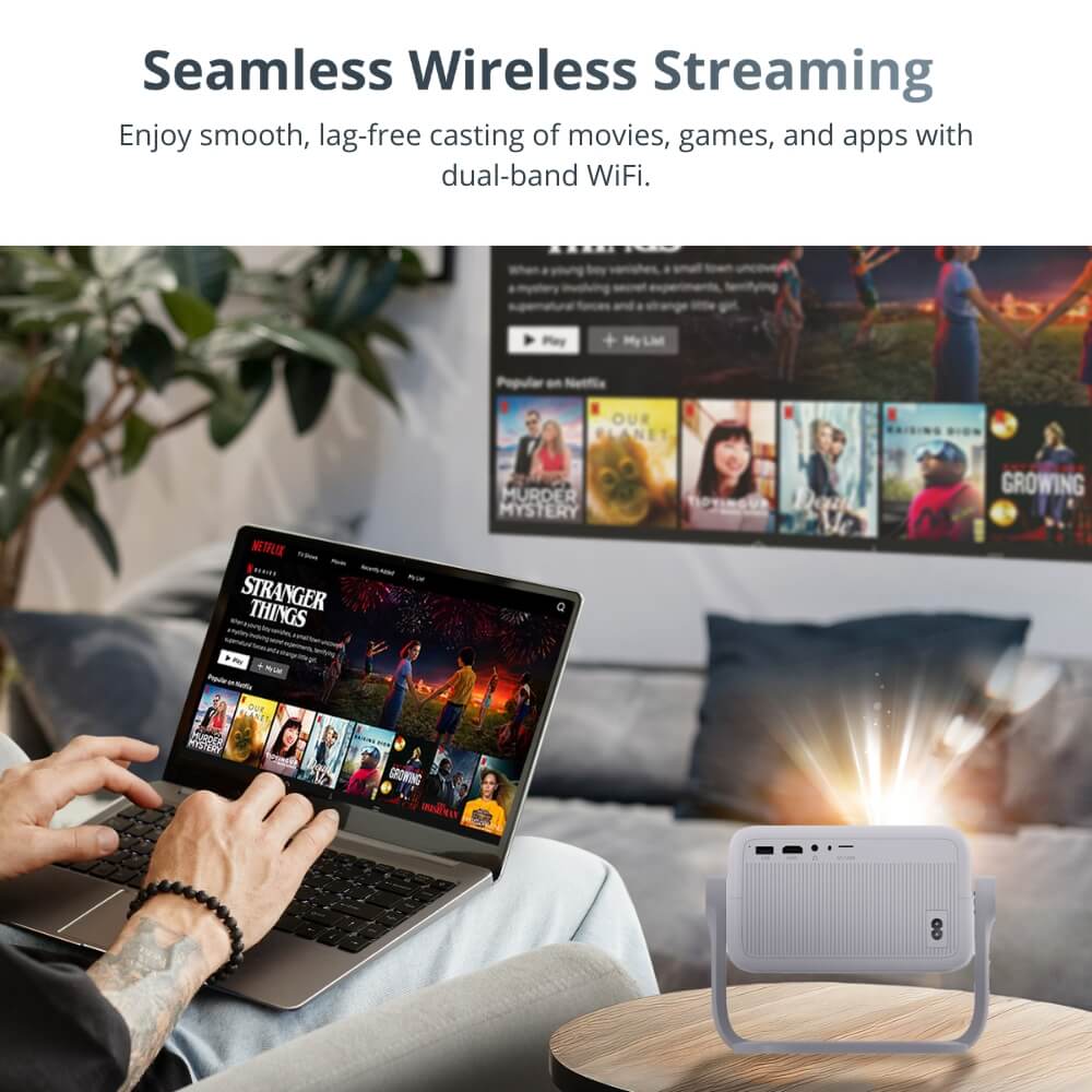 Photograph by unknown artist, a person streams Netflix content on a silver laptop displaying "Stranger Things" while a white portable projector casts "Murder Mystery" and other titles onto a living room wall with a bright beam