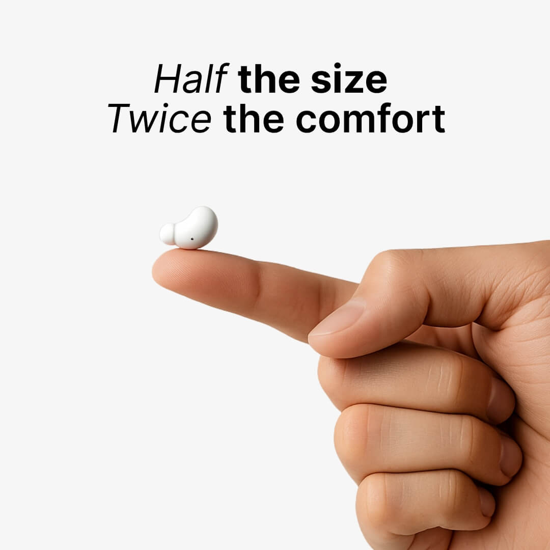 Digital product photo of a tiny white bean-shaped wireless earbud resting on a human index finger against a light background, with overlay text Half the size Twice the comfort
