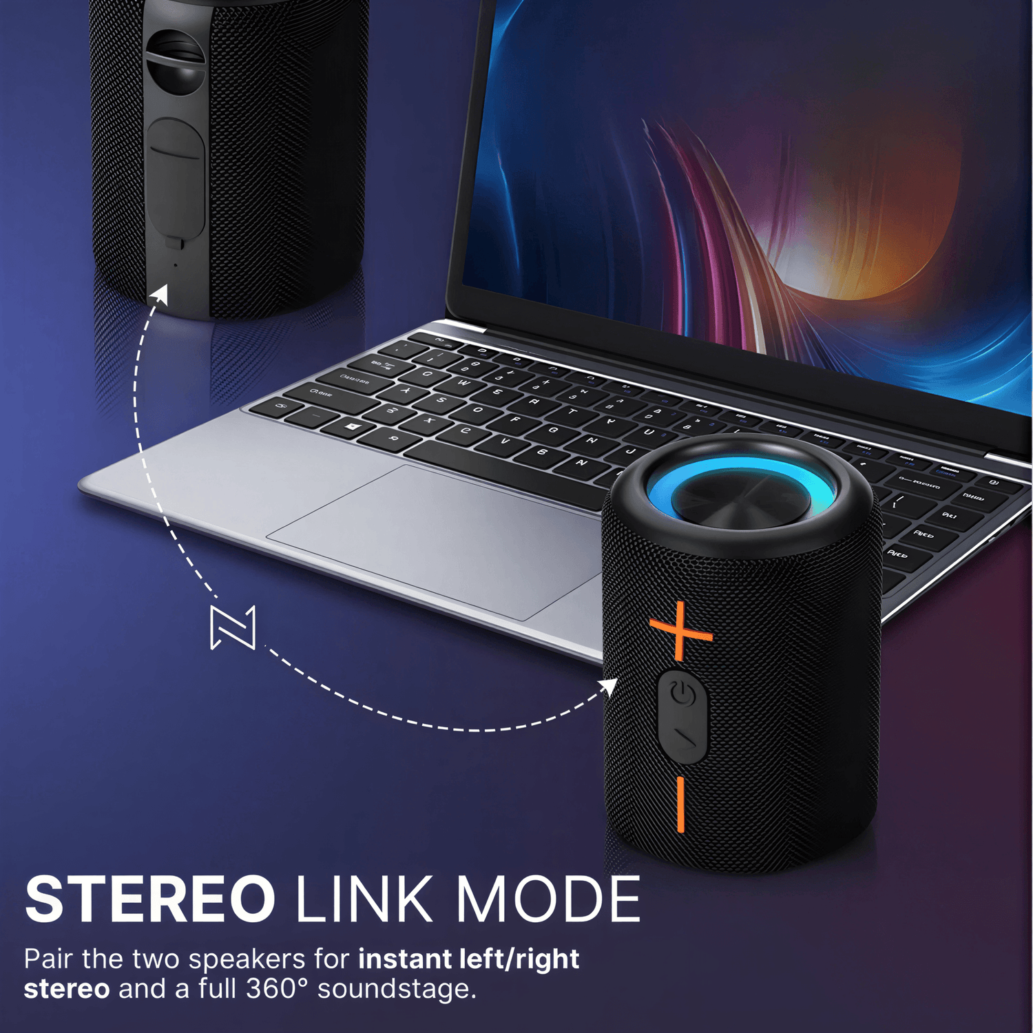 Product image showcasing two black wireless speakers in Stereo Link Mode, one with a blue glowing top and orange power/volume buttons, linked by a dashed line to a second speaker, positioned in front of a silver laptop with a colorful abstract screen on a dark blue surface