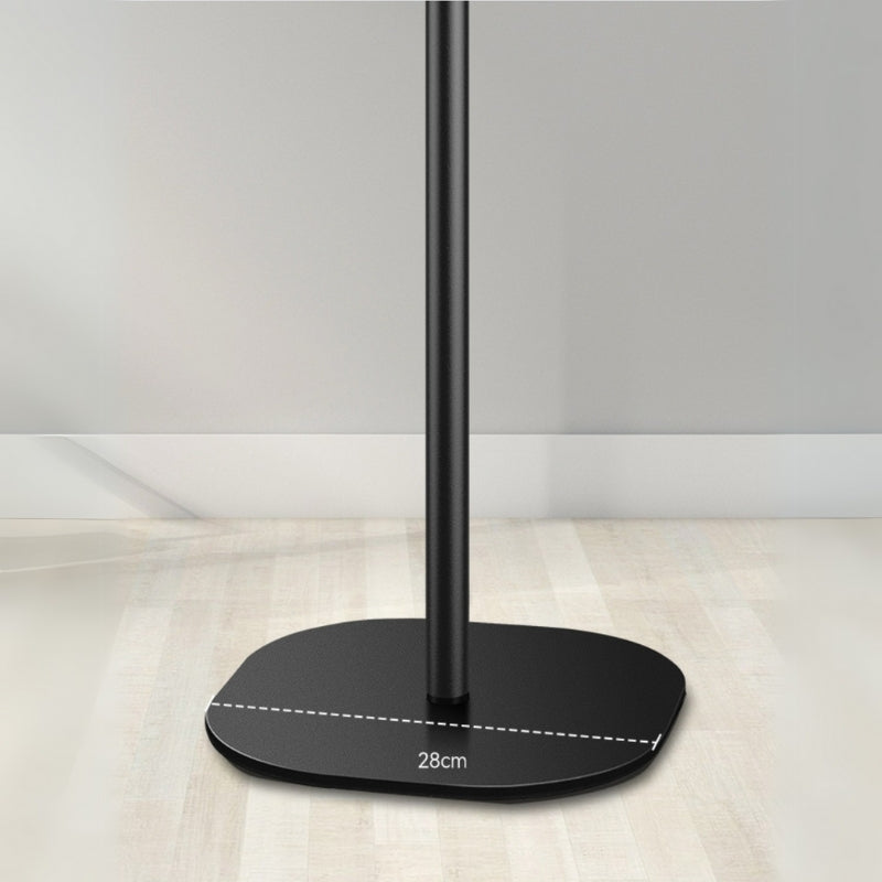 Photograph of a black metal stand base with an irregular oval shape and a vertical pole, displaying a 28cm width measurement over a light wooden floor and white wall