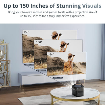A black portable projector on a gold-rimmed marble coffee table in a modern living room casts layered images of a woman with a hat and camera in a sunny, arid landscape, demonstrating 150, 100, and 84-inch projection sizes above a white media console