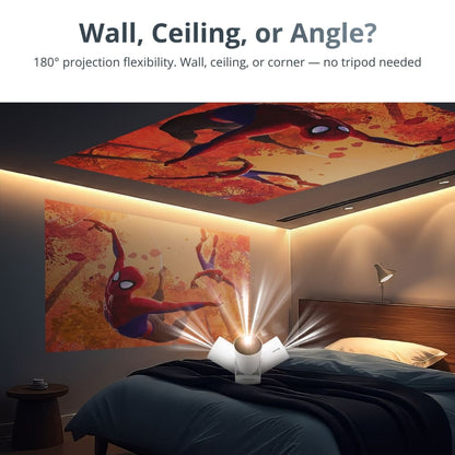 Digital projection in a modern bedroom showing a white projector with three fan-like wings casting vibrant Spider-Man artwork onto both the wall and ceiling above a dark blue bed under warm LED strip lighting