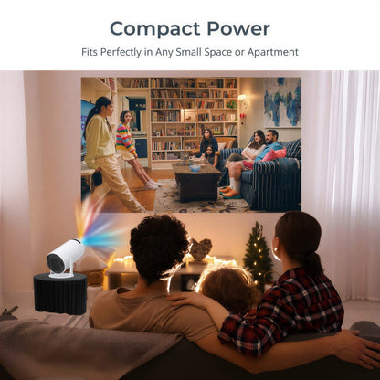 A compact white projector emits colorful rainbow light while displaying a film of friends in a book-lined living room, watched by a family on a couch in a cozy home with an illuminated Christmas tree