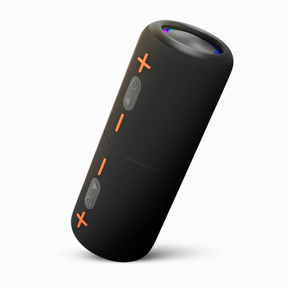 Product photography of a black cylindrical portable Bluetooth speaker with textured mesh finish, prominent orange plus, dash, and x markings, gray power and directional control buttons, and a subtle rainbow illuminated top