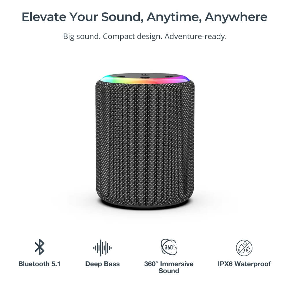 A dark gray portable Bluetooth speaker with a textured mesh fabric exterior and a vibrant rainbow LED light ring on its top surface, set against a clean white background